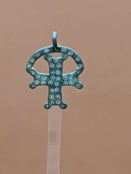 Bronze cross pendant decorated with raised circular dots from Byzantine period